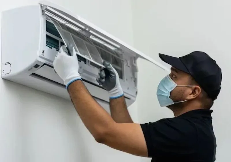 CoolNest technician servicing a split AC in a Hyderabad home